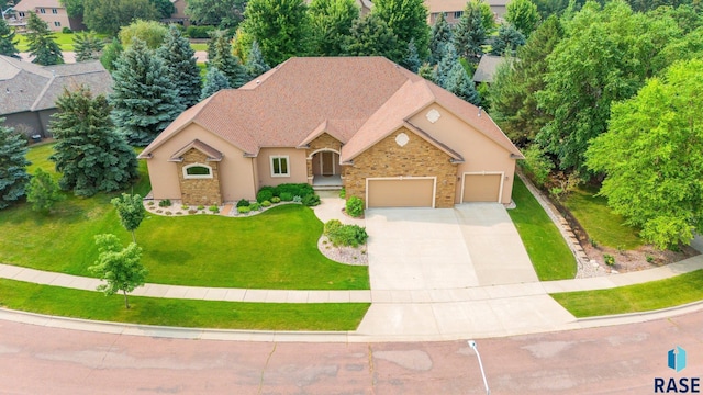 view of front of house with a garage and a front lawn