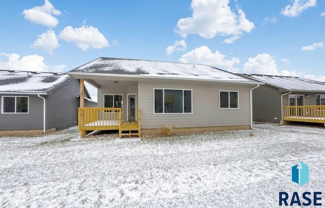 back of property featuring a deck