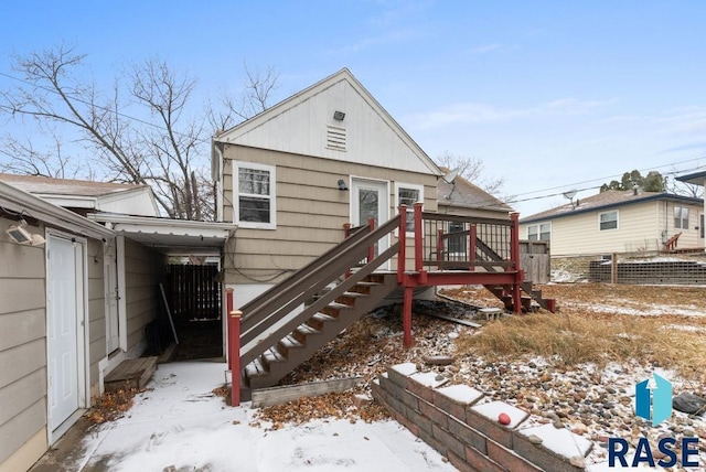 snow covered property featuring a wooden deck