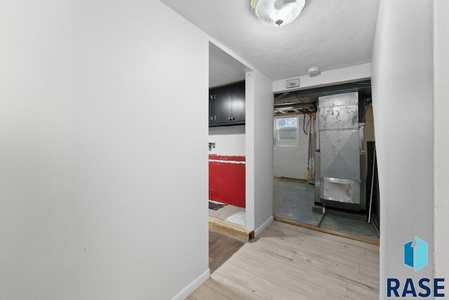 hallway featuring hardwood / wood-style floors and heating unit