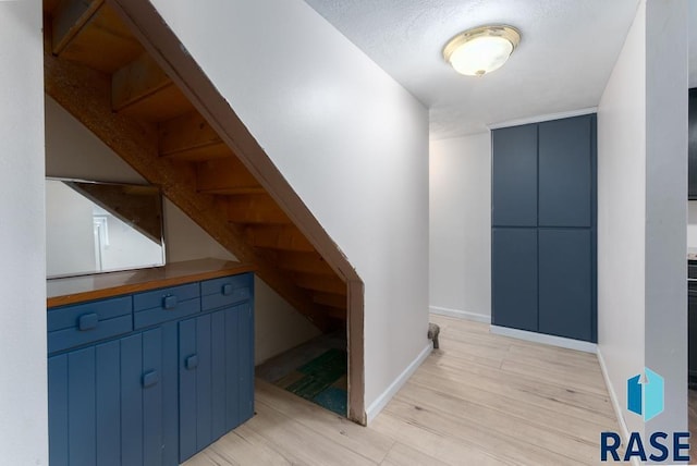 stairway with hardwood / wood-style floors