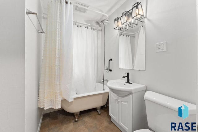 full bathroom featuring shower / bath combo, toilet, and vanity