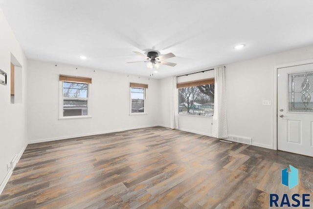 unfurnished room with dark hardwood / wood-style floors and ceiling fan