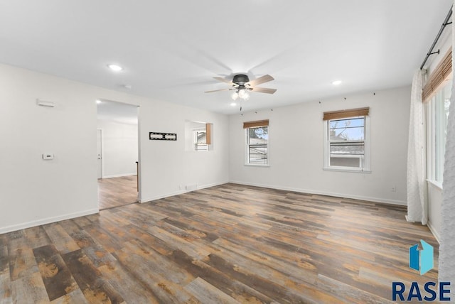 spare room with ceiling fan and dark hardwood / wood-style flooring