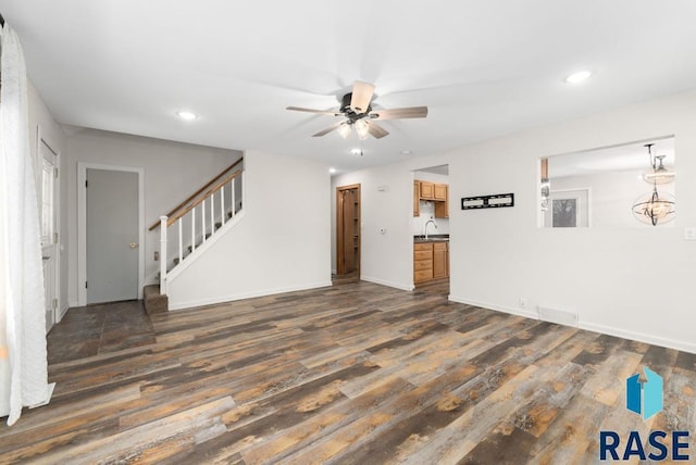 unfurnished living room featuring ceiling fan, dark hardwood / wood-style flooring, and sink