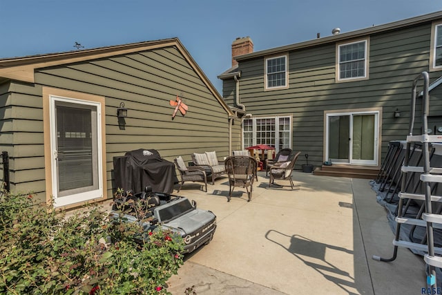 back of property with outdoor lounge area and a patio