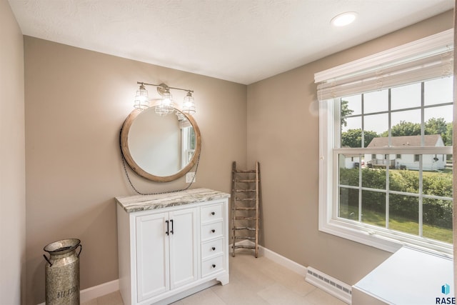 bathroom with vanity and a textured ceiling