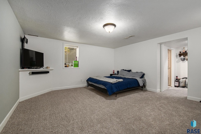 bedroom with carpet flooring and a textured ceiling