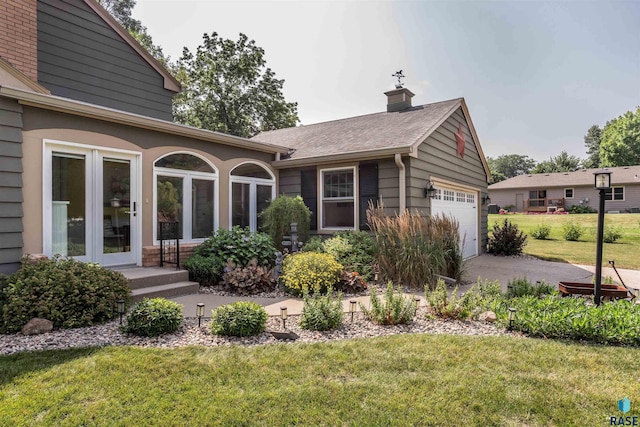 view of front facade featuring a garage and a front lawn