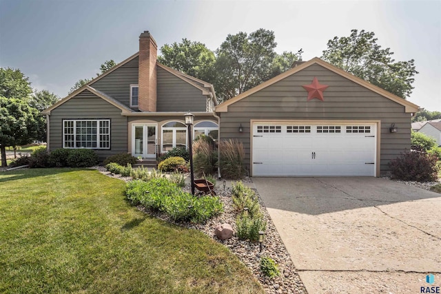 view of front of property with a garage and a front yard