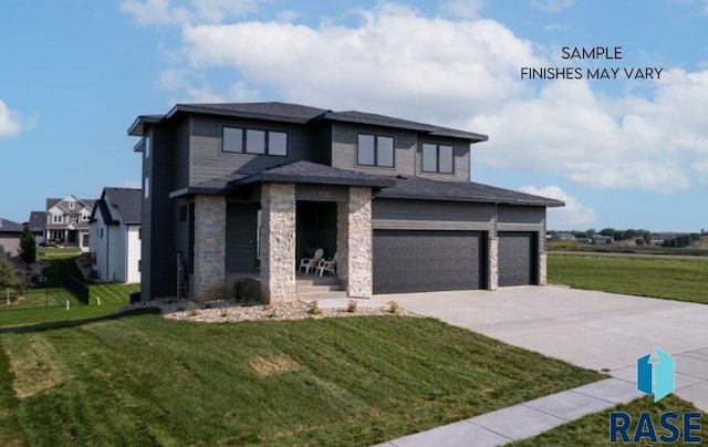 view of front of home with a front yard and a garage