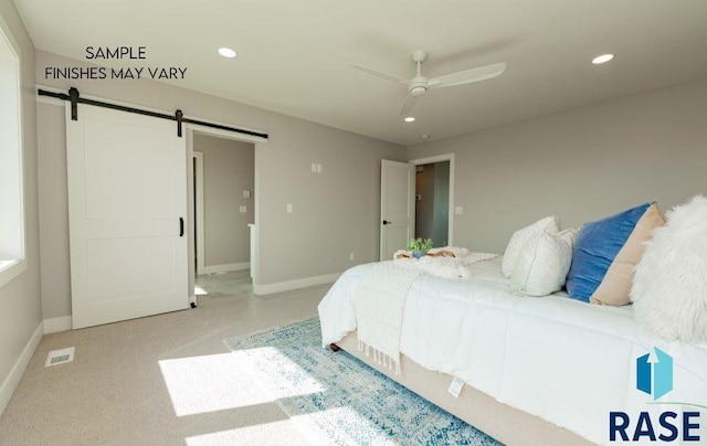 bedroom featuring light carpet, a barn door, and ceiling fan