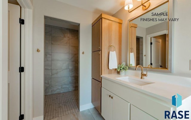 bathroom with tile patterned floors, vanity, and a tile shower