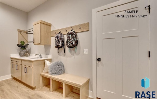 mudroom with sink and light hardwood / wood-style floors