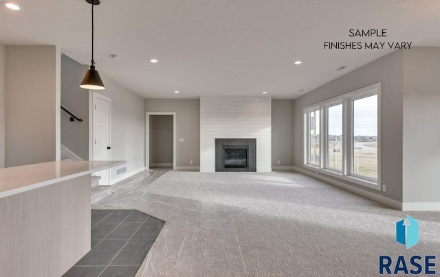 unfurnished living room with dark colored carpet and a fireplace