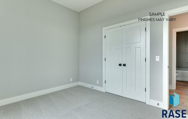 unfurnished bedroom featuring light colored carpet