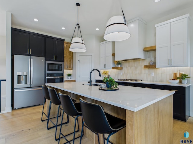6609 E Hawker Cir, Sioux Falls, SD 57110 - kitchen with appliances with stainless steel finishes, a sink, dark cabinets, open shelves, and backsplash