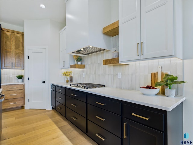 6609 E Hawker Cir, Sioux Falls, SD 57110 - kitchen featuring custom exhaust hood, open shelves, stainless steel gas stovetop, backsplash, and light countertops