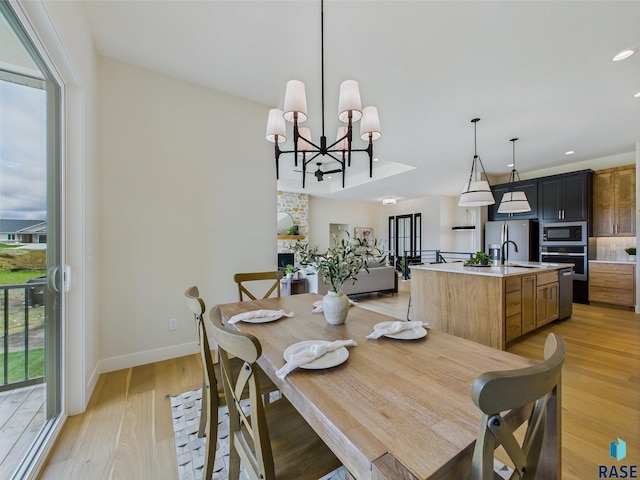 6609 E Hawker Cir, Sioux Falls, SD 57110 - dining space featuring light wood-type flooring, baseboards, a chandelier, and recessed lighting