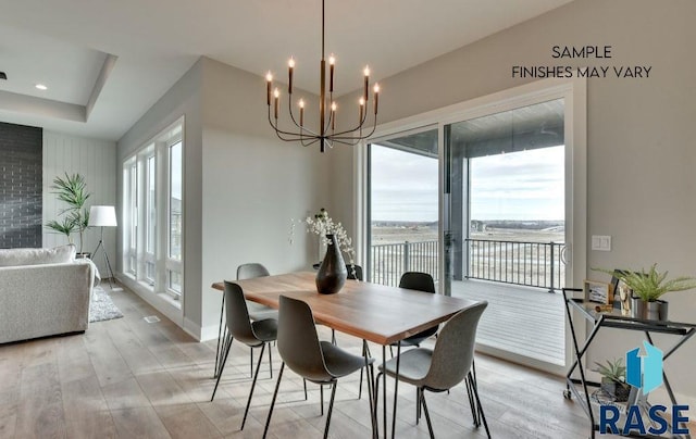 dining space with plenty of natural light, a chandelier, and light hardwood / wood-style flooring