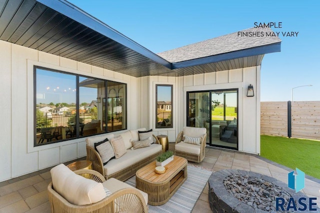 view of patio / terrace with an outdoor living space with a fire pit and fence