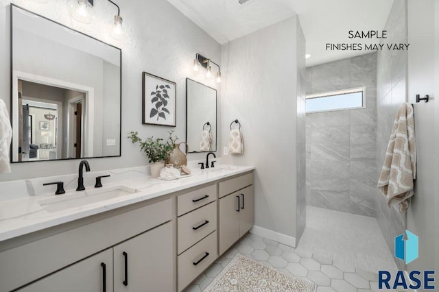 bathroom featuring tile patterned floors, walk in shower, a sink, and double vanity