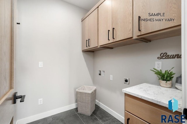 laundry area with cabinet space, baseboards, dark tile patterned flooring, hookup for a washing machine, and electric dryer hookup