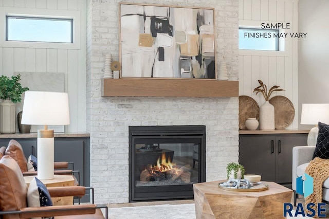 living room with a fireplace and a wealth of natural light