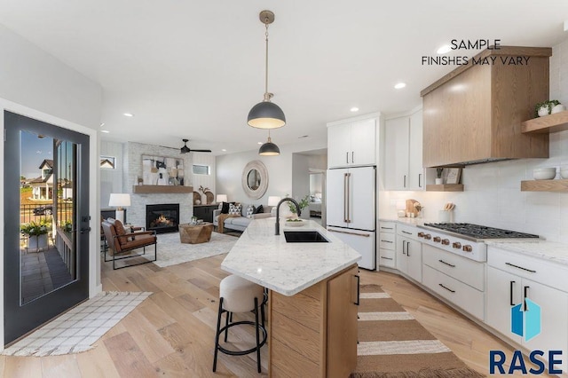 kitchen featuring white appliances, a sink, light wood-style floors, open shelves, and tasteful backsplash