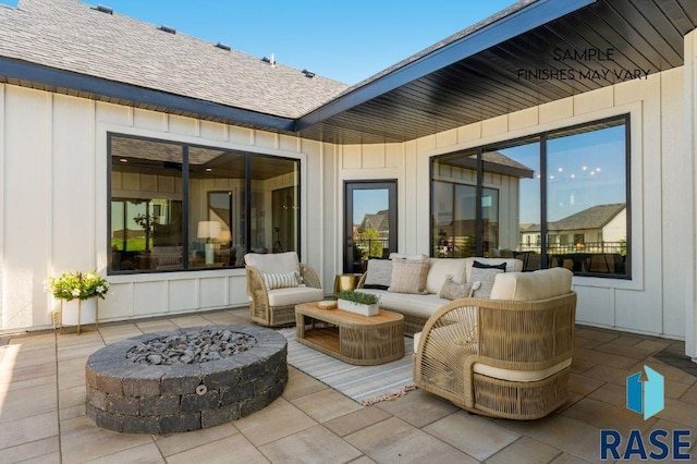 view of patio featuring an outdoor living space with a fire pit