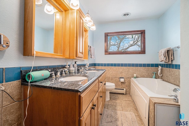 bathroom with baseboard heating, tile patterned floors, a tub to relax in, toilet, and tile walls