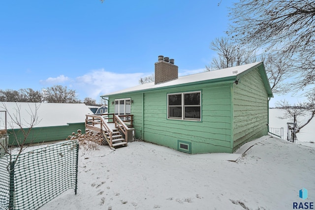 snow covered house featuring a wooden deck