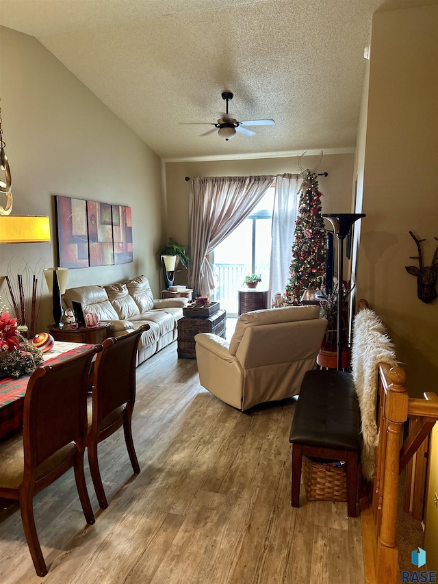 living room featuring a textured ceiling, ceiling fan, lofted ceiling, and hardwood / wood-style flooring