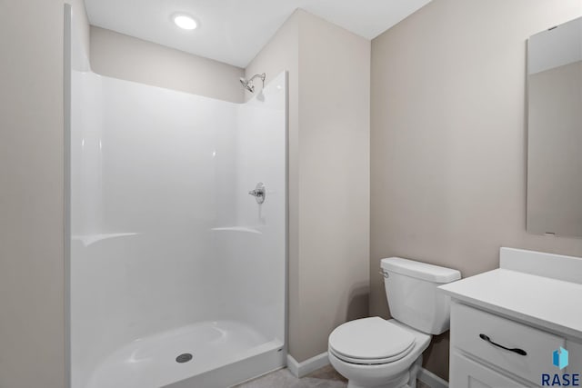 bathroom with a shower, vanity, and toilet