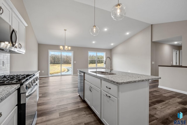 kitchen featuring sink, stainless steel appliances, an island with sink, lofted ceiling, and white cabinets