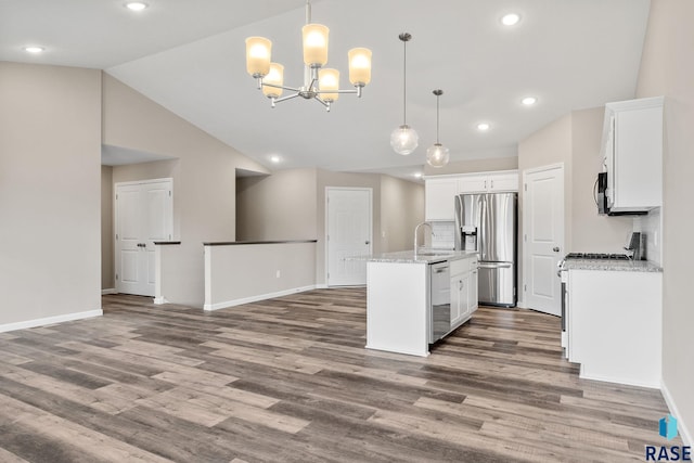 kitchen featuring pendant lighting, stainless steel appliances, white cabinetry, and sink