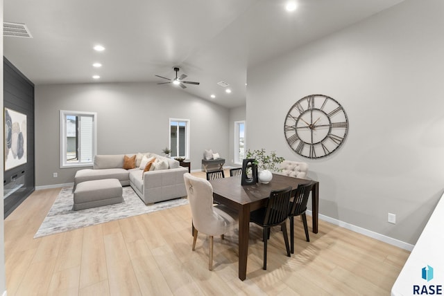 dining space with light hardwood / wood-style floors, ceiling fan, and lofted ceiling