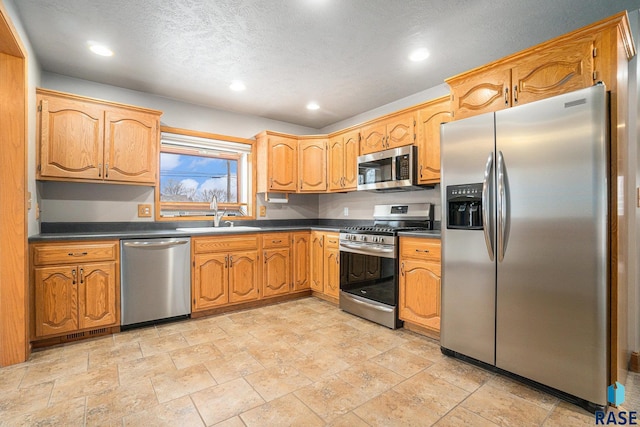 kitchen with sink and appliances with stainless steel finishes