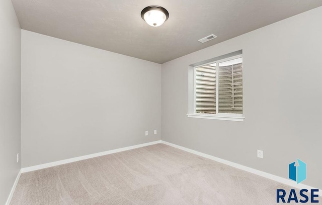 unfurnished room featuring light carpet