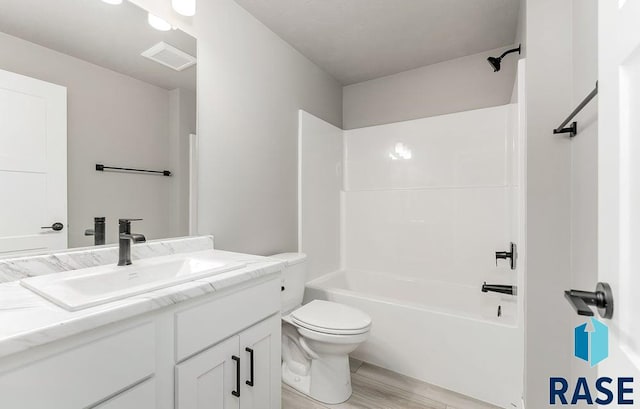 full bathroom featuring shower / tub combination, vanity, wood-type flooring, and toilet