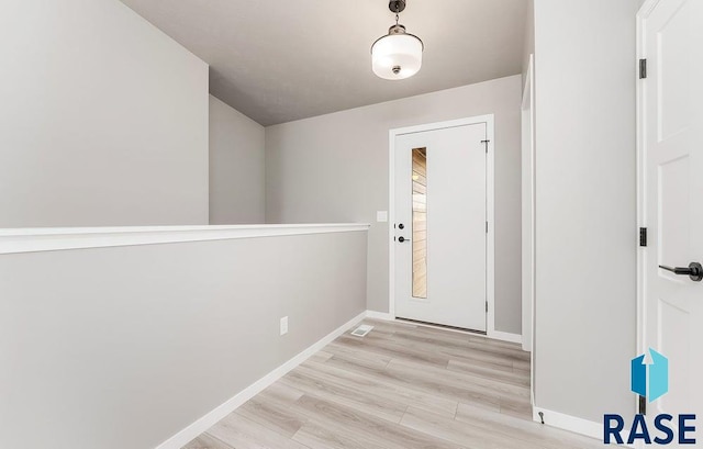 foyer entrance with light wood-type flooring