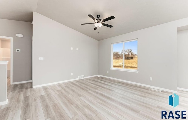 spare room with ceiling fan and light wood-type flooring