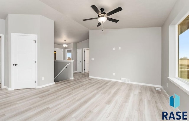 unfurnished living room with ceiling fan, light wood-type flooring, and vaulted ceiling