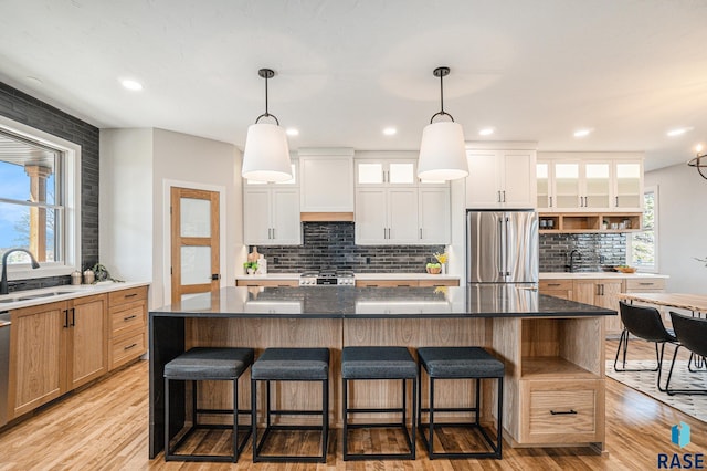 kitchen with white cabinets, a spacious island, and appliances with stainless steel finishes