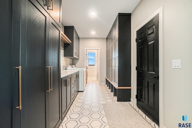 interior space featuring washer and clothes dryer and cabinets