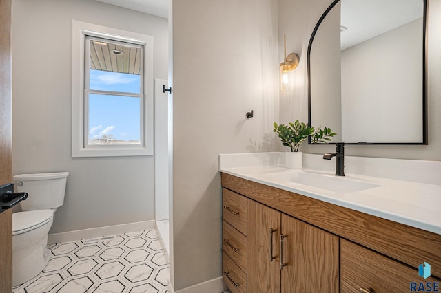 bathroom featuring vanity and toilet