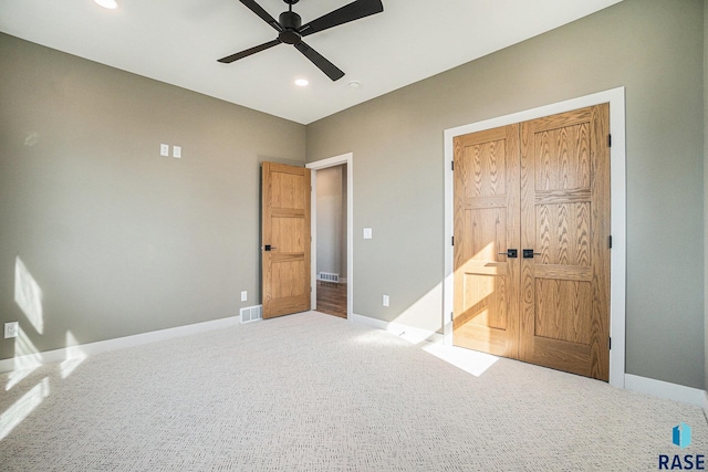 unfurnished bedroom featuring ceiling fan, a closet, and carpet floors