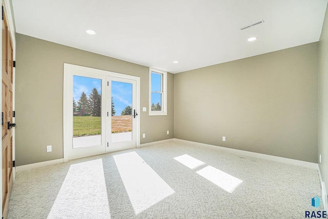 unfurnished room with light colored carpet