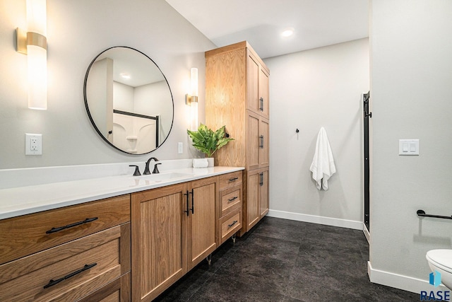 bathroom with vanity, a shower with shower door, and toilet