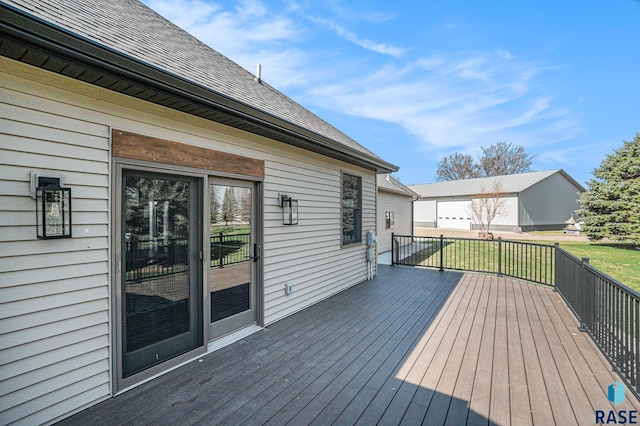 wooden deck featuring a lawn